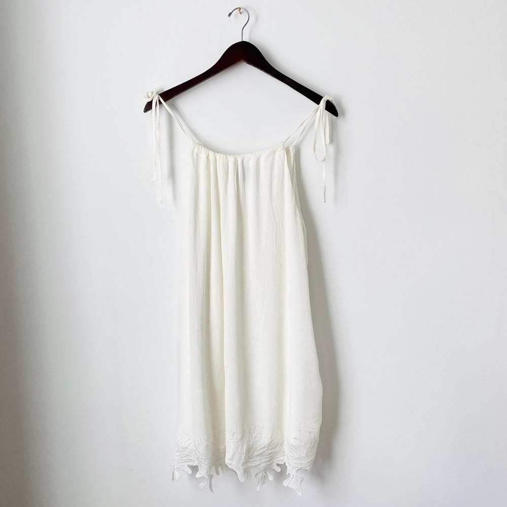 White Sumer dress with detailing at the bottom